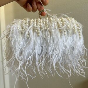 Brand new white feather and pearl clutch with two straps.